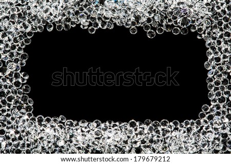 Square frame made from many small crystal on black surface.