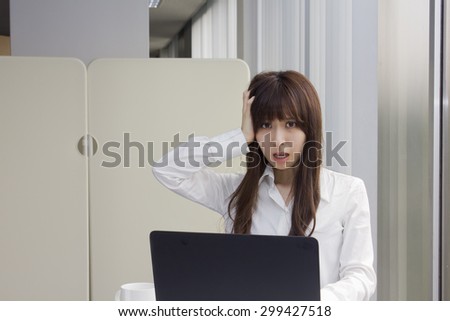 Business woman surprised in front of Laptop computer in office