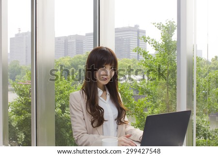 Business woman standing in front of Laptop computer in office
