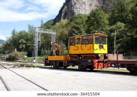 Train crane carriage. Hydraulic crane mounted on a railroad car (freight train) for lifting the timber.  Special railway wagon.