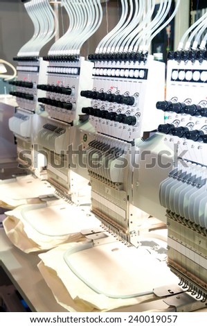 Textile - Professional and industrial embroidery machine. Machine embroidery is an embroidery process whereby a sewing machine or embroidery machine is used to create patterns on textiles.