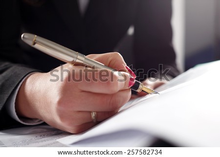 Business woman writing fountain pen head.