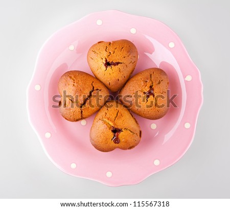heart shaped muffins with rose hips jam on a ping palate isolated with clipping path