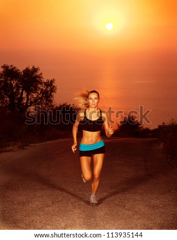 Image of of sporty blond female running along the road over sunset, slim athletic woman run in marathon, active girl doing fitness exercise outdoors, weight loss, body care, healthy lifestyle