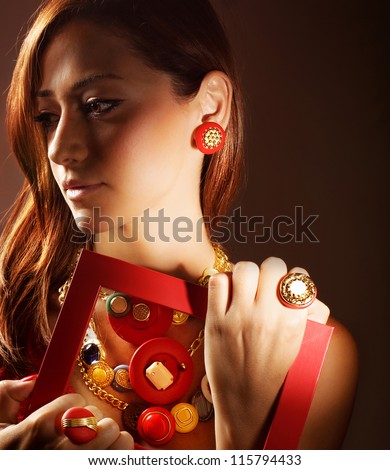 Photo of beautiful girl wearing stylish colorful accessories, closeup portrait of pretty woman in luxury jewelry isolated on brown background, glamour young lady, fashion and style concept