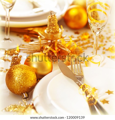 Picture of Christmas table setting still life, festive white utensil decorated with golden candle and shiny xmas tree ball toys, romantic holiday dinner, New Year party, luxury table decorations