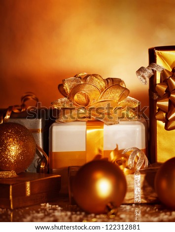 Picture of Christmas gifts variety on dark grunge background, golden wrapping paper, New Year presents, xmas decoration, holiday party, festive ornament, decorative bauble, Christmastime still life