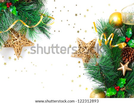 Photo of Christmastime border, Christmas tree branch decorated with golden stars, ribbons, bubbles and fir cones isolated on white background, festive floral frame, New Year greeting card