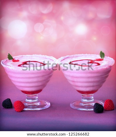 Picture of tasty ice cream in glass cup with red heart decoration, fresh raspberry fruits, romantic pink dessert for Valentine day party, frozen yogurt, purple blur background, love concept