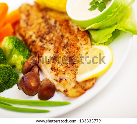 Tasty healthy fish fillet with steamed vegetables, healthy nutrition, dinner in restaurant, delicious meal