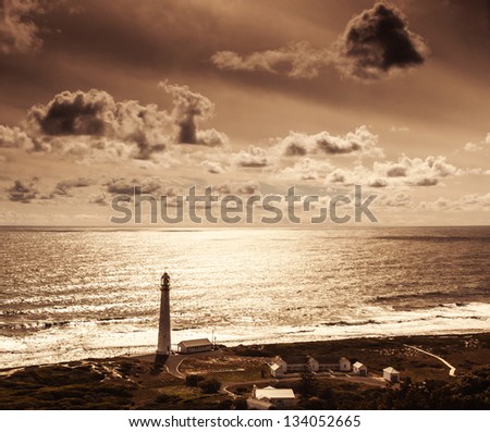 Lighthouse over sunset, beautiful seascape, Kommetjie at Slangkop Punt near Cape Town, nature of South Africa Western Cape