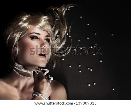Fashion portrait of beautiful seductive woman ripped her luxury pearl beads, closeup on face with perfect stylish makeup, blond sexy female model, desire and sexuality concept