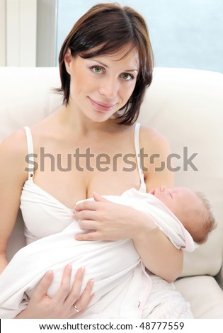 Happy young mother holding a baby
