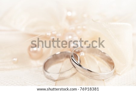 stock photo Pair of golden wedding rings over invitation card decorated 