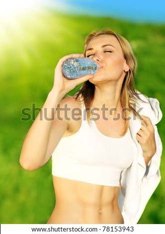 Healthy woman drinks water, doing sport outdoor, fitness, diet & body care concept
