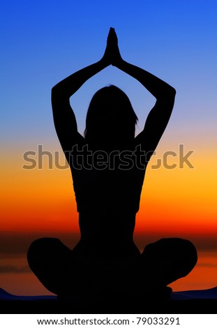 Healthy woman doing yoga outdoor, sunset over sea, body care & meditation concept
