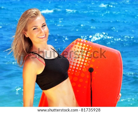 Beautiful sporty female holding body board, outdoor beach portrait, water sport, healthy lifestyle concept