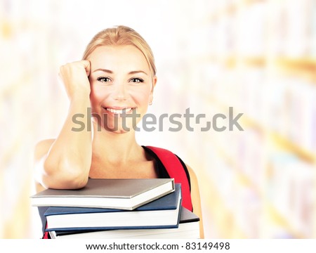 Smiling student girl portrait with books, studying in library, with copy space, back to school concept