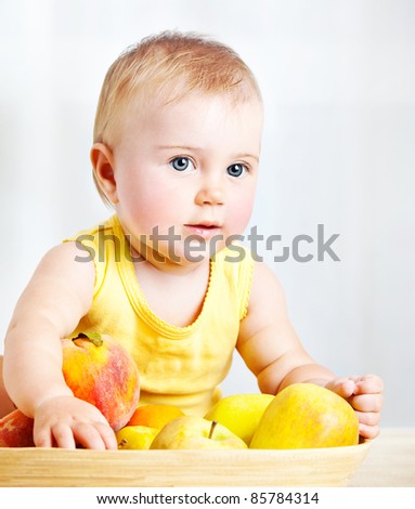 Little baby with fruits, closeup portrait, concept of health care & healthy child nutrition