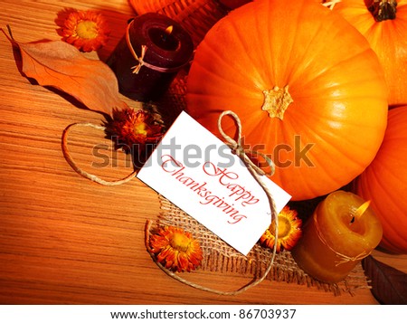 Thanksgiving holiday, pumpkin border still life decoration with candles on the wooden table background, greeting card with text space, harvest concept