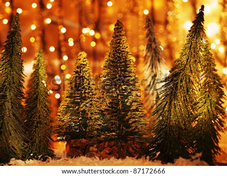 Christmas tree forest, holiday background with winter ornament & abstract blur bokeh lights decoration