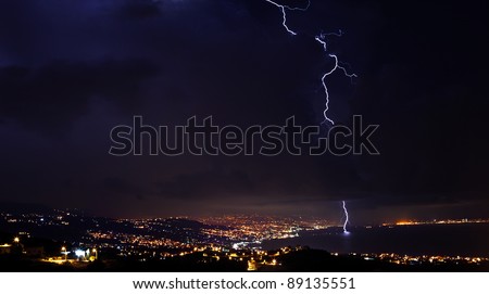Lightning, thunderstorm at night sky, overcast winter weather with dramatic sky over city