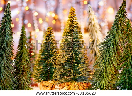 Christmas tree forest, holiday background with winter ornament & abstract defocused lights decoration