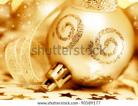 Golden Christmas tree ornament, winter holidays decoration, ornamental decorative bauble, gold background with magic glowing sparks