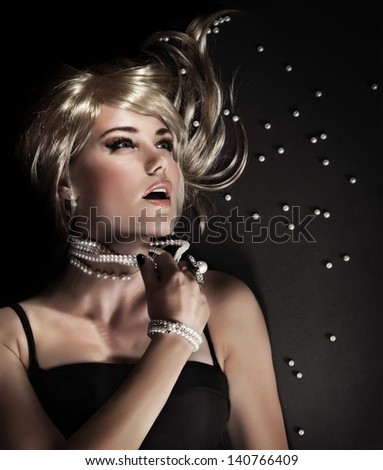 Fashion portrait of beautiful seductive woman ripped her luxury pearl beads, closeup on face with perfect stylish makeup, blond sexy female model, desire and sexuality concept