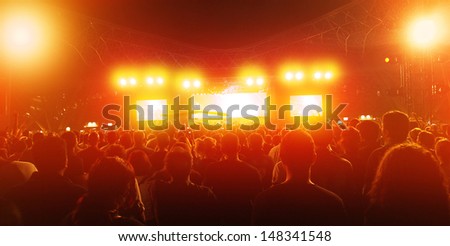 Rock concert, crowd of young people enjoying music in nightclub, holiday celebrations, dance club, red illumination, active lifestyle