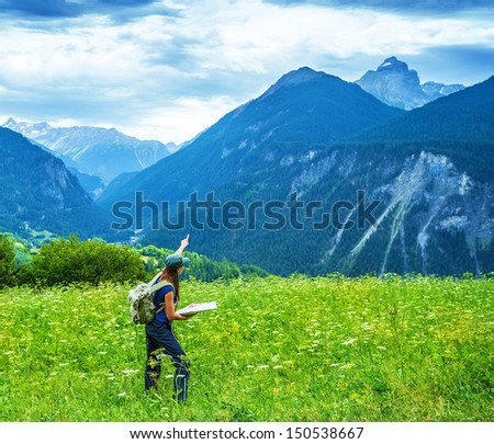 Traveler girl trekking in the mountains, searching right direction on the map, green picturesque valley, summer vacation, active lifestyle, travel and tourism concept