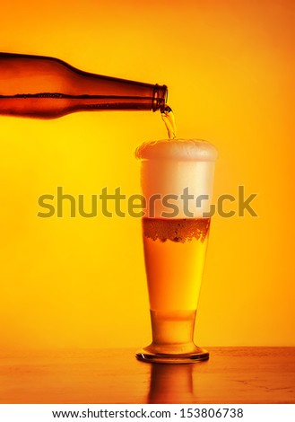 Waiter pouring beer, glass of a cold drink isolated on yellow warm background, alcoholic beverage, festival of beer, oktoberfest autumn holiday