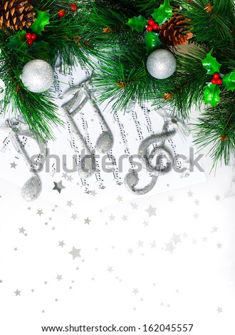 Photo Of Christmas Tree Border, Silver Treble Clef, Festive Melody On The Notes Page, Musical Sound, Traditional Christmastime Song, Green Pine Tree Branch Decorated With Cones, Red Berry And Baubles