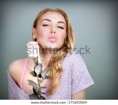 Portrait of sweet female with rose isolated on gray background, kiss with love, Valentine day, romance and tenderness concept