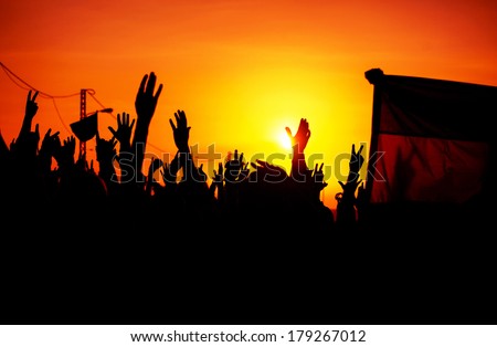 Revolution, people protest against government, man fighting for rights, silhouettes of hands up in the sky, threat of war  - stock photo