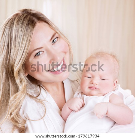 Closeup portrait of cute happy mommy holding on hands nice sleeping baby, day dreams, loving family, happiness concept