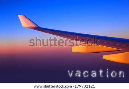 Plane wing in sunset light, line of horizon, air space, luxury transportation, traveling and vacation concept