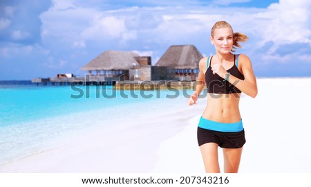 Beautiful sportive female running on the beach, workout on luxury Maldives resort, doing fitness exercises outdoors, healthy lifestyle, active summer vacation concept