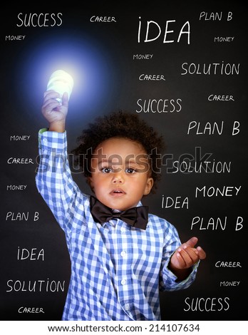 Portrait of little African genius boy with lightbulb in the hand on blackboard background, back to school, find solution concept