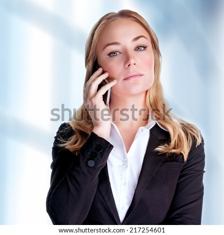 Portrait of attractive confident businesswoman speaking on phone in the office, communicate with business partner, modern life concept