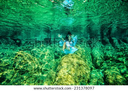 Underwater swimming, beautiful girl enjoying transparent refreshing water, summer vacation on tropical island, diving to coral garden on sea bottom