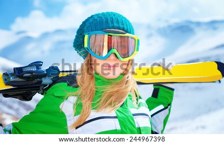 Closeup portrait of cute ski trainer,  active woman wearing a mask and holding in hands ski, active winter vacation, happiness and enjoyment concept