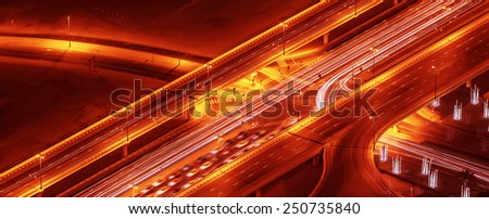 Night roads panoramic background, bird eye view on illuminated highway, modern motorway in Dubai city, UAE