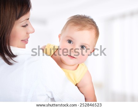 Happy mother and baby portrait, people having fun at home, healthy family enjoying life, parenting lifestyle