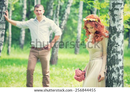 Loving couple walking between birch in the park on sunny day, back side, happy wedding day, love and romance
