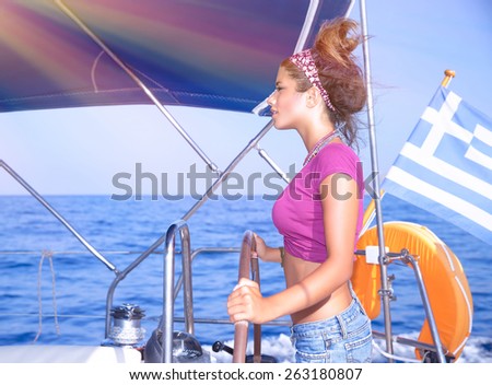 Side view of a  sexy girl behind the wheel of a yacht, young woman enjoying summer vacation on luxury sailboat, recreation travel and active lifestyle concept
