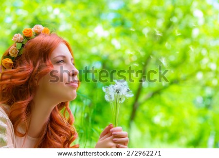 Closeup portrait of nice happy woman holding in hands dandelion flowers, having fun in fresh green park, enjoying beauty of spring nature