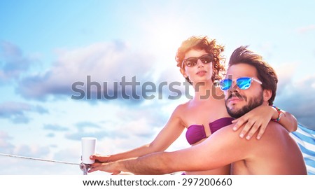 Beautiful young family spending hot summer days on the sailboat, traveling along sea, romantic relationship, enjoying honeymoon