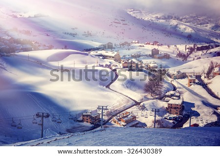Air view on beautiful ski resort, mountain covered with snow, luxury little cottages and chalets, spending winter holidays in Lebanon