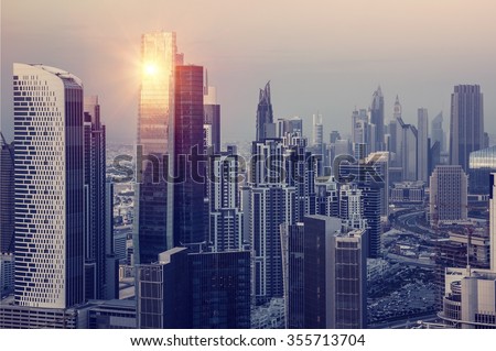 Dubai downtown in the evening, luxury modern buildings in bright yellow sunset light, futuristic cityscape of United Arab Emirates